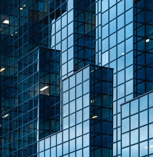 The modern blue glass facade of a building