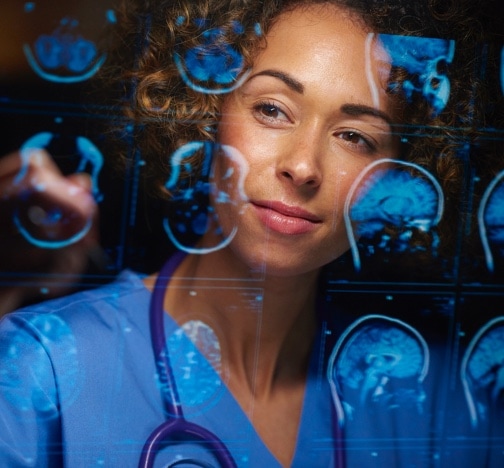 a female doctor analyzes the digitally generated scans of a human brain