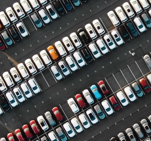 Aerial view of the parked new cars at the automotive plant