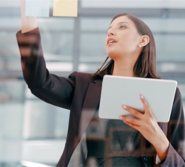 A young businesswoman using a digital tablet during a brainstorming session in a modern office