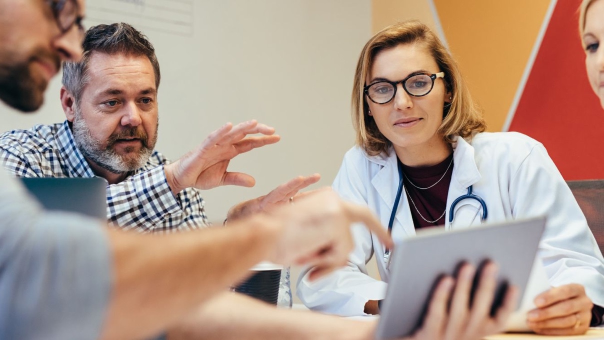 a group of health care workers gathered around a table