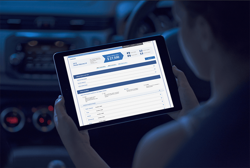 person using tablet showing detailed car information inside an automobile