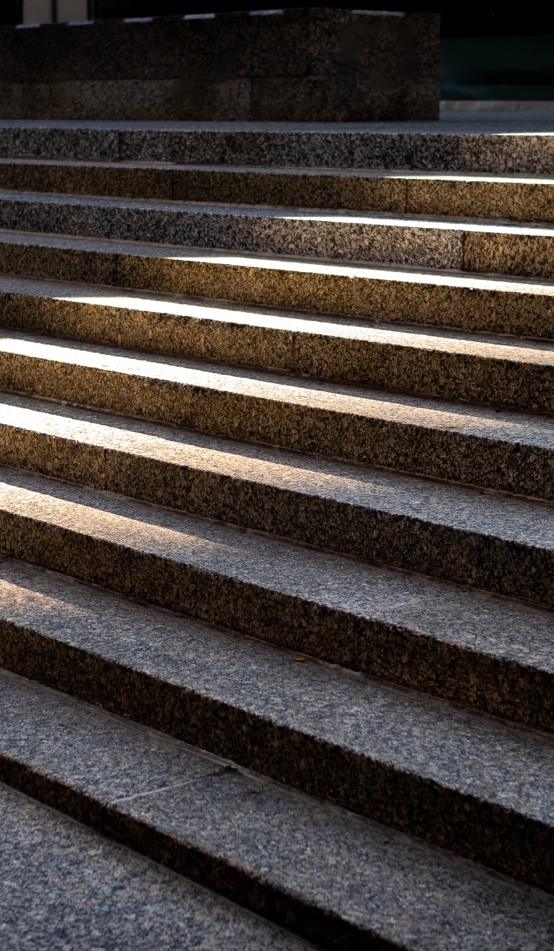 Sunshine forming a path up outdoor marble steps