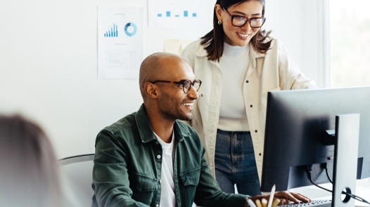 Two business people working on a project in an office.