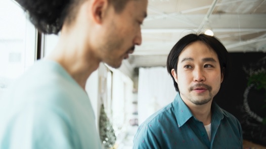 Two young men talking in an office