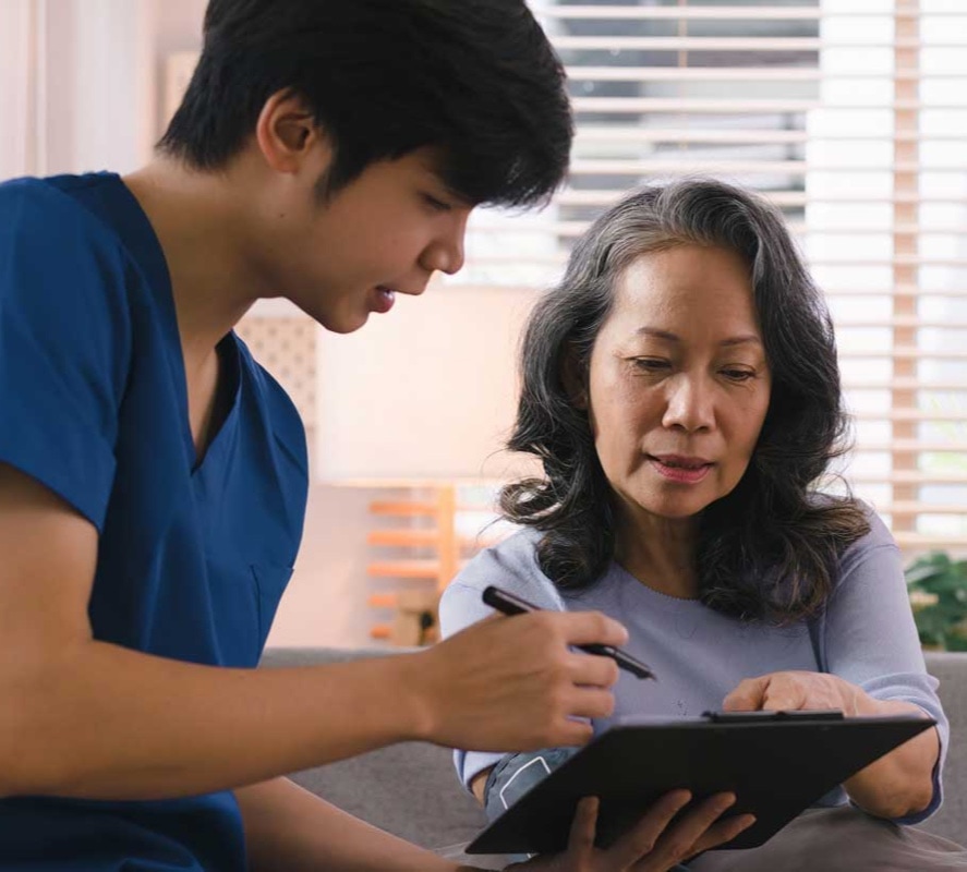 A male nurse showing results to an elderly woman