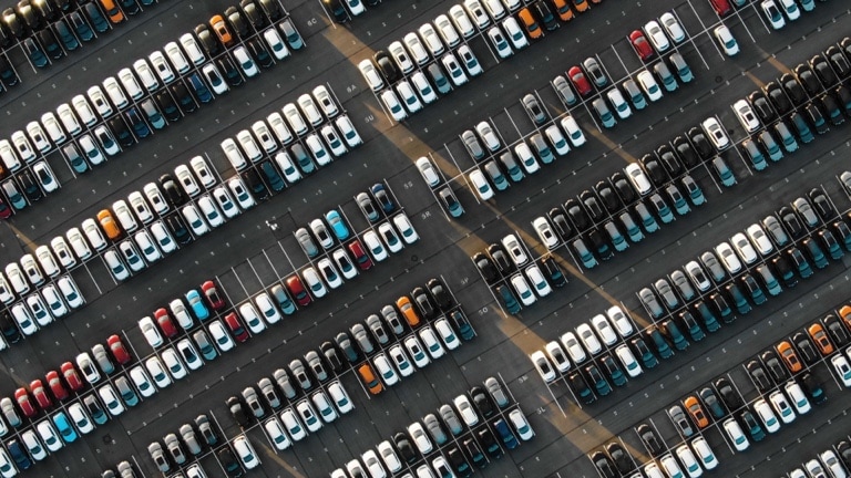 Aerial view of the parked new cars at the automotive plant