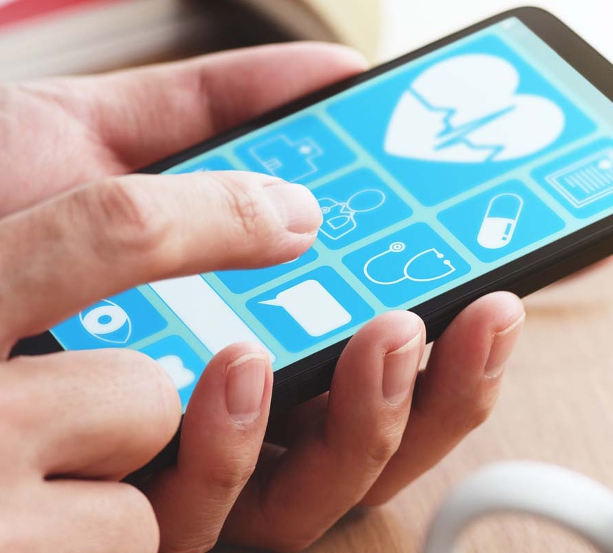 A man interacting with the screen of his mobile device with a health app.