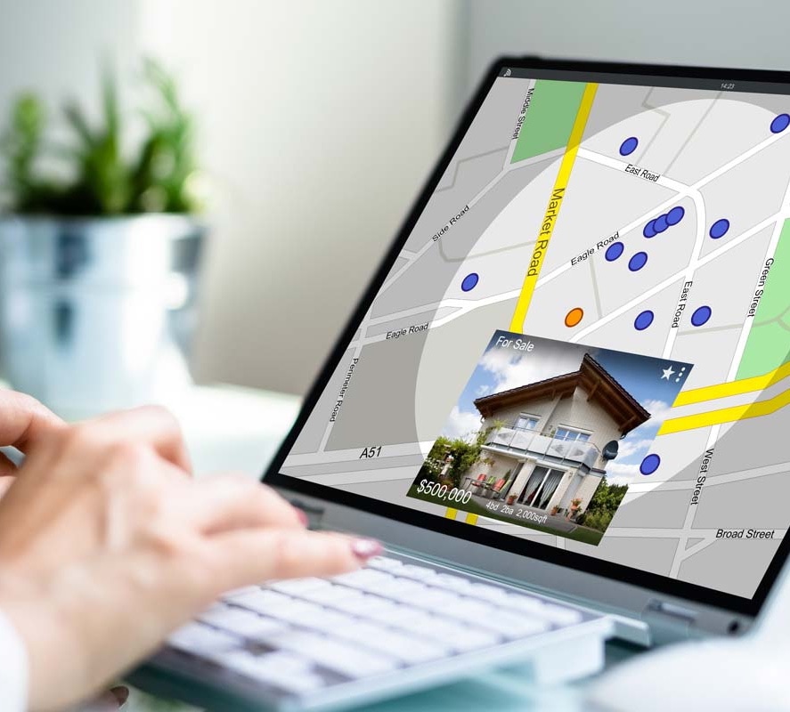 A woman looking at a map on a laptop