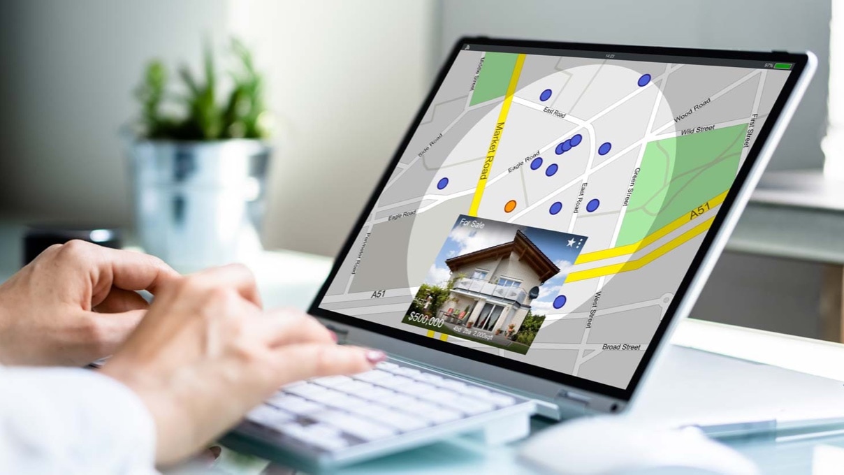 A woman looking at a map on a laptop