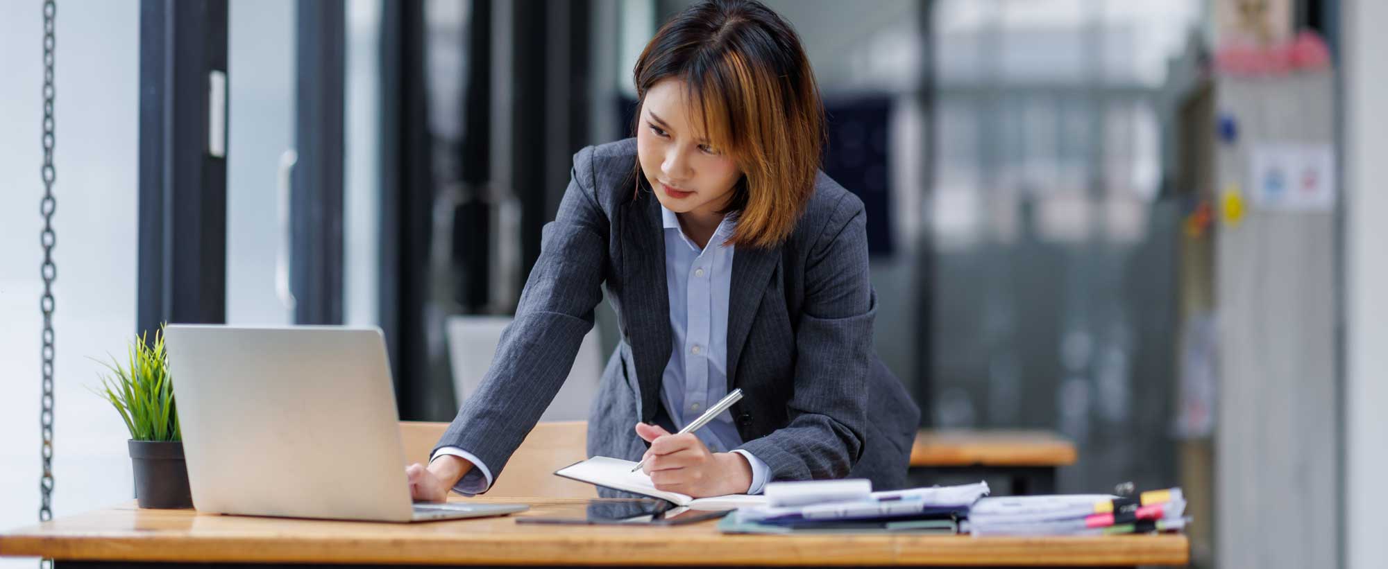 Women writing at desk