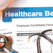 Healthcare benefit forms including: enrollment forms and applications, stethoscope, calculator.