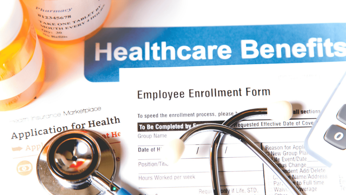 Healthcare benefit forms including: enrollment forms and applications, stethoscope, calculator.